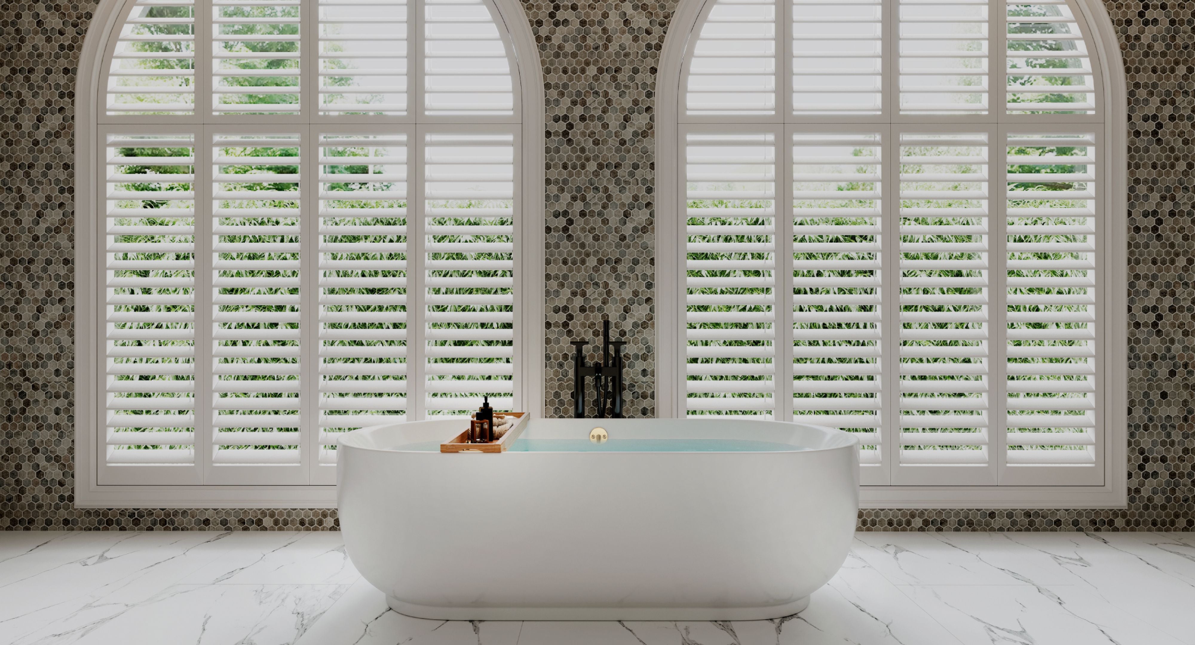 White freestanding bathtub in a bathroom with Primsoph bathroom essentials.